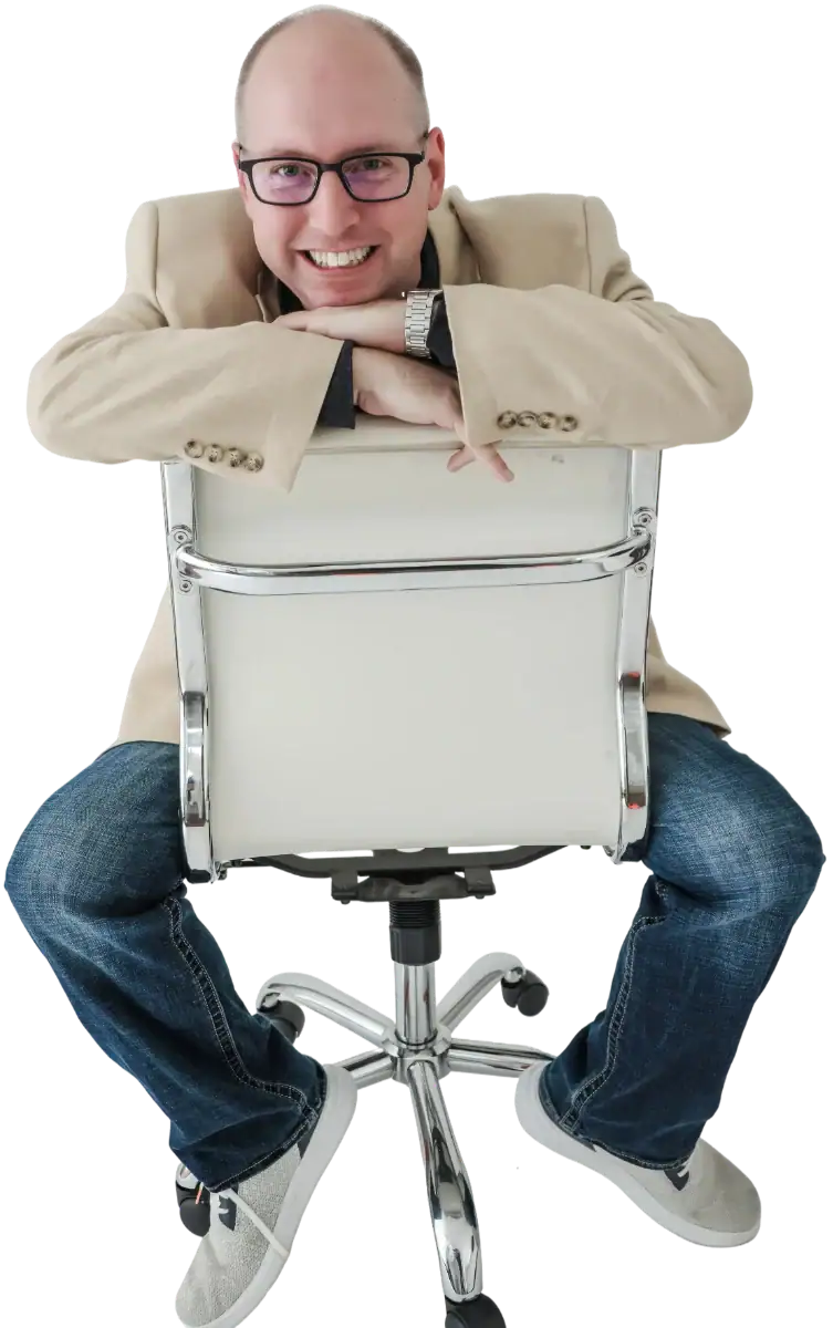 Jeremy Simpson of Bull City Web Design in a tan blazer, sitting backwards on a chair