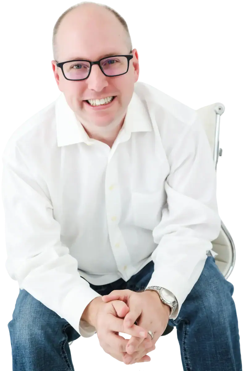 Jeremy Simpson of Bull City Web Design seated in a white dress shirt, hands clasped